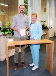 Theo receiving the award for his console table from Dids McDonald, OBE